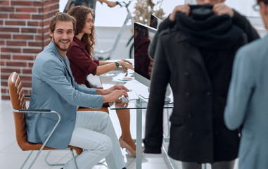 group of designers and tailors working in the Studio