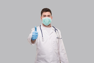 Male Doctor Showing Thumb Up Wearing Medical Mask and Gloves.