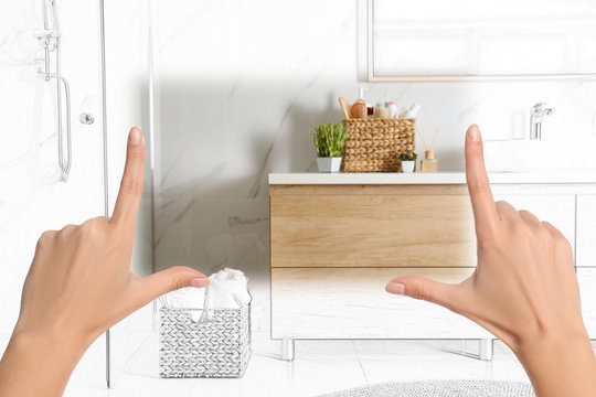 Woman showing frame gesture and making bathroom real out of drawing