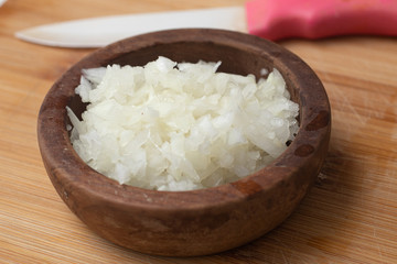 Chopped Onion in a wooden bowl