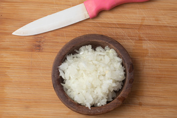 Chopped Onion in a wooden bowl