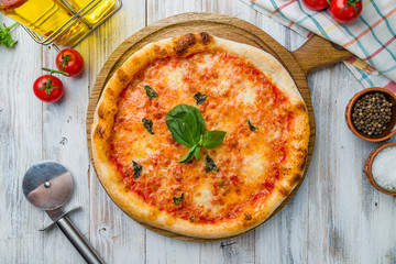 Italian pizza Margherita on white wooden table