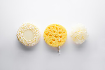 Bath sponge set on a gray background, flat lay. Bath accessories. Hygiene products.
