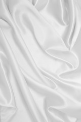 Smooth elegant white silk or satin luxury cloth texture as wedding background. Luxurious background design