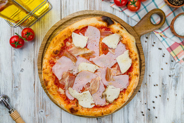 Italian meat pizza on white wooden table