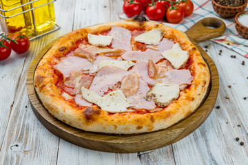 Italian meat pizza on white wooden table