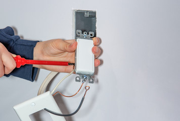 Mounting and installing a wall switch in a drywall