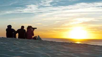 Fototapeta premium Sunset at sea, people have a rest 