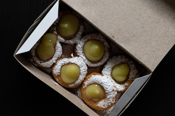 Mini doughnuts with custard and chocolate sauce and nuts