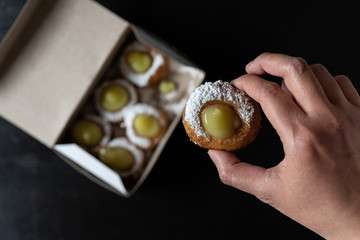 Mini doughnuts with custard and chocolate sauce and nuts