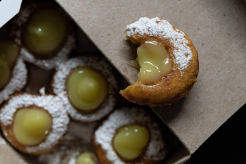 Mini doughnuts with custard and chocolate sauce and nuts