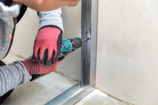 man fasten metal profile frame to the wall for draywall bulkhead