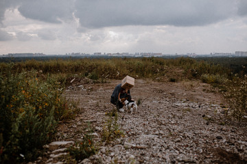 Self-isolation. Human without a face. Urban landscape. Without a head. Box. A mountain of junk.