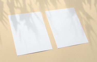 Blank paper poster flyers letterhead on orange textured background with soft shadows and floral light overlay as template for design presentation, promotion, portfolios etc.