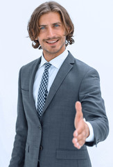 Smiling friendly businessman offers a handshake