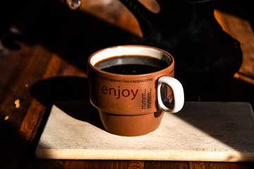 Cup of morning coffee on a wooden table. The joy of the morning.