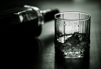 glass of water with ice and bottle