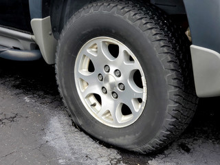 Fototapeta na wymiar close up of dusty flat tire on vehicle