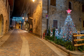 Street of the ancient village of illuminated for the Christmas holidays