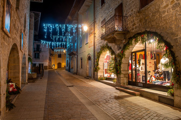 Fototapeta na wymiar Street of the ancient village of illuminated for the Christmas holidays