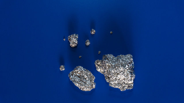 silver ore on blue background
