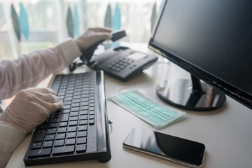 Close up on hands in medical gloves typing on keyboard. Protective care. Emergency problem. Healthcare employee practitioner, distance working and learning concept. Modern technology background.