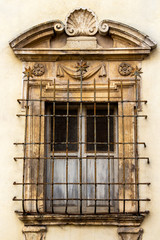 Beautiful architectural detail of Palazzo Puccetti or Puccetti Palace in Cingoli, Marche Region, Province of Macerata, Italy, ornate window with rusty window security bars