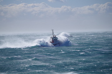 Tug during bad weather at sea / storm