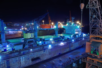 Fototapeta na wymiar Chemical tanker inside dry dock at night
