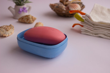 pink hand soap, towels next to it