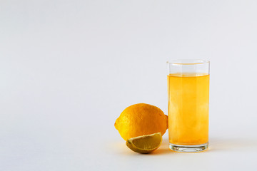 vitamin C pills in glass with water isolated on white background, fresh lemon and lime. citrus fruit with slice of lime on white table. to strengthen the immune system. Healthy lifestyle. copy space.