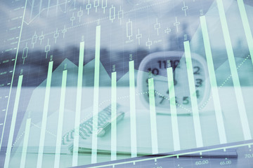 Multi exposure of financial graph drawings and desk with open notebook background. Concept of forex
