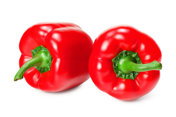 two red sweet bell peppers isolated on white background