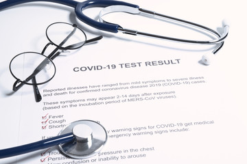 Positive test result for COVID-19 or novel coronavirus pandemic. Stethoscope and novel coronavirus test result on doctor's table