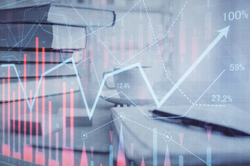 Double exposure of financial chart drawing and desktop with coffee and items on table background. Concept of forex market trading