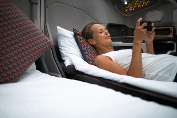 Pretty, young woman abord a first class commercial flight using their cell phone during flight