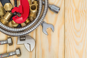 Plumbing spare parts, faucet, tool and hose on wooden boards are used to replace or repair