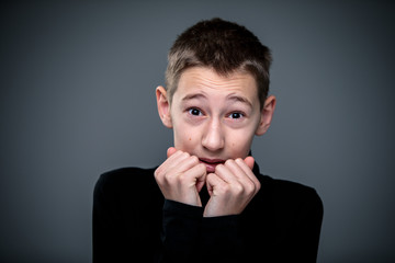 Grief-stricken little boy - feeling intense sorrow, remorse, sadnesss - studio portrait - vivid emotions series