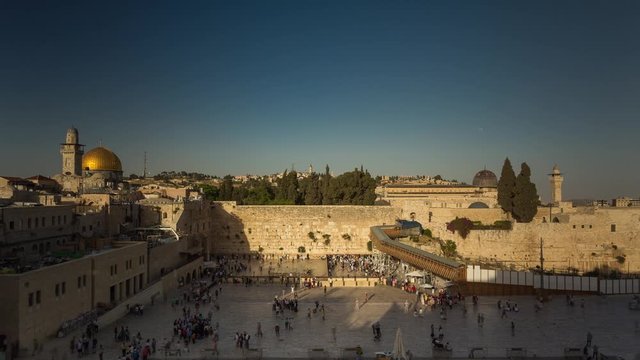 People on a beautiful evening pray near the Western Wall in Jerusalem. Israel. Timelapse. Dome of the Rock.