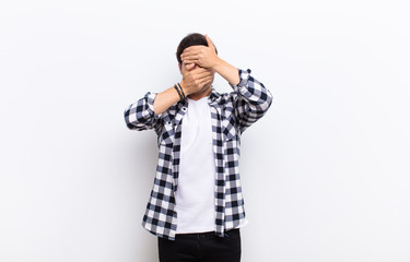  covering face with both hands saying no to the camera! refusing pictures or forbidding photos