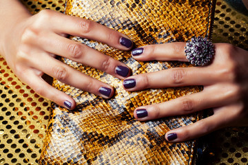 pretty fingers of african american woman holding money closeup with purse, luxury jewellery on...