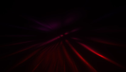 Fototapeta premium Light particles in motion, creating a burst of glowing multicolored rays on a black background. Energetic glow lights wallpaper.