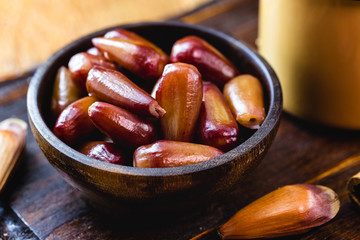 pine nuts cooked with shell. pine nut seed on rustic wooden table. Brazilian cuisine, consumed in the winter and June parties.