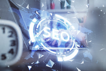 Double exposure of woman hands working on computer and seo hologram drawing. internet search...