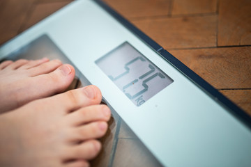 Feet on a scale, obesity becomes an increasingly common health problem