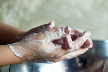 Child washes hands, antibacterial protection. Evening lighting, warm light.
