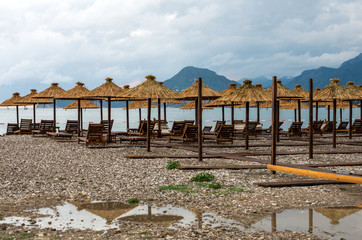 umbrellas on an empty beach, stormy weather