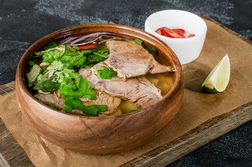 Vietnamese fresh rice noodle soup with beef, herbs and chili. Asian cuisine