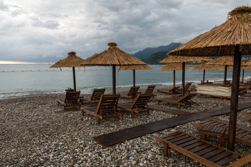 umbrellas on an empty beach, stormy weather