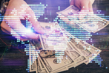 Multi exposure of financial theme drawing hologram and USA dollars bills and man hands. Business concept.